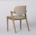 The Mila Beige PU Dining Chair is a modern solid wood chair featuring a beige PU upholstered seat and backrest, shown angled against a plain white background.