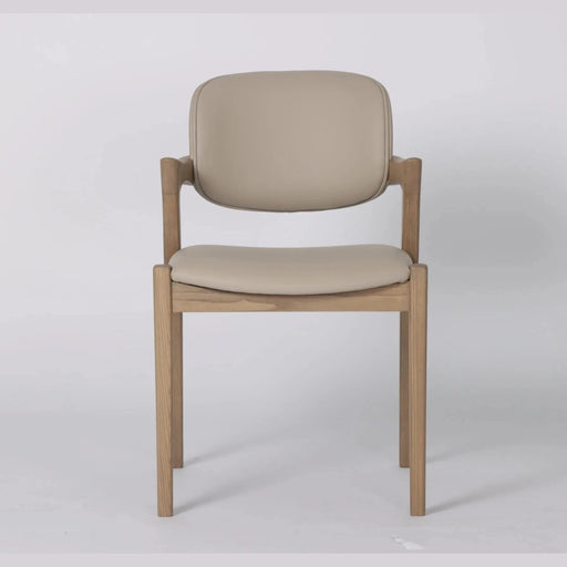 The Mila Beige PU Dining Chair is a modern solid wood chair with a light beige cushioned seat and backrest, shown against a plain white background.
