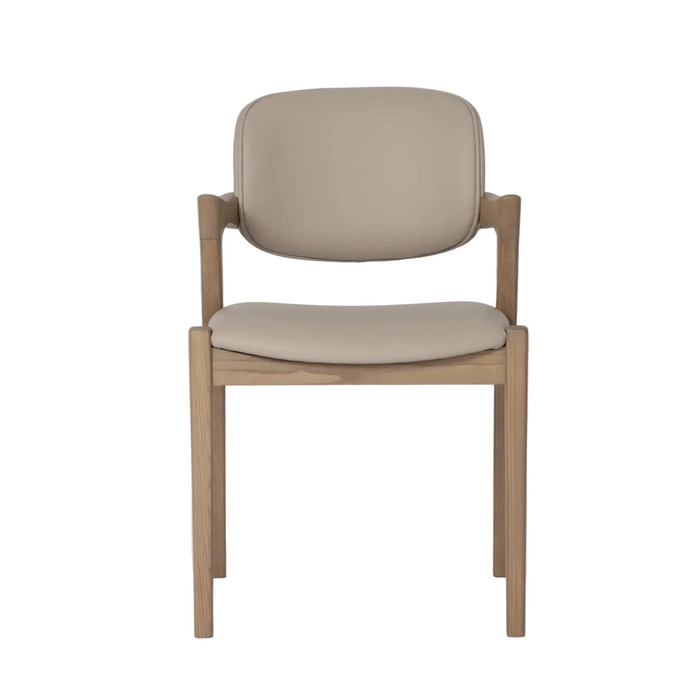 The Mila Beige PU Dining Chair features a solid wood frame with a light beige PU cushioned seat and backrest, a modern simple design, and straight legs, displayed against a plain white background.