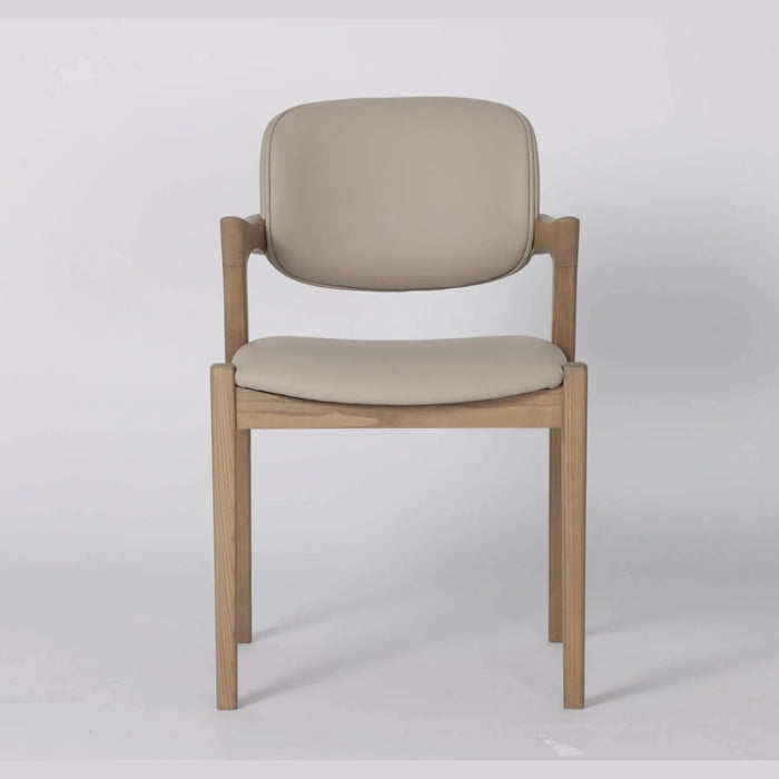 The Mila Beige PU Dining Chair is a modern solid wood chair with a light beige cushioned seat and backrest, shown against a plain white background.