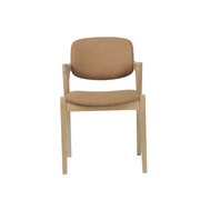 A Mila Dining Chair with a cushioned light brown seat and backrest is displayed against a white background. This Mila Dining Chair, crafted from solid wood, showcases a simple and modern design that brings elegance to any space.