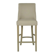The Millie Counter Stool features a high backrest, easy-clean beige leatherette upholstery, and light wooden legs, shown from the front on a white background.