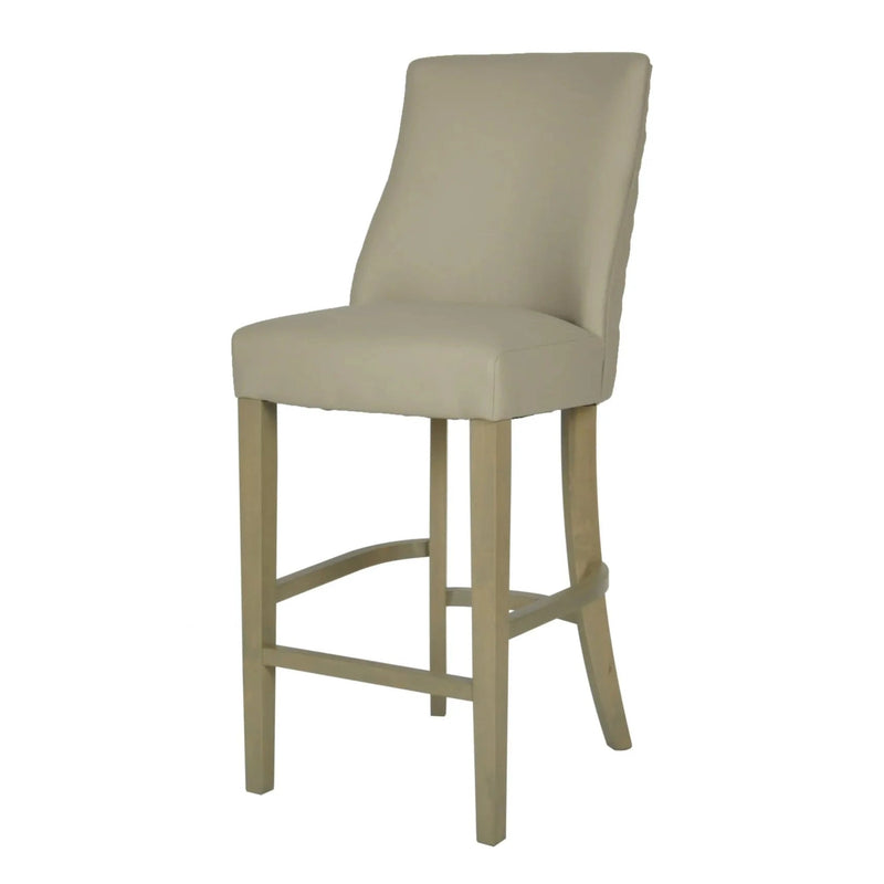The Millie Counter Stool features a beige easy-clean leatherette, high backrest, curved seat, footrest bar, and light wood legs—perfect for elevating your dining area.