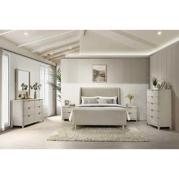 Modern bedroom featuring the Parma Bedframe with taupe fabric headboard, light gray upholstery, matching nightstands and dressers, beige rug, wall art above the bed, plants, décor accents, light wood floors, and vaulted ceiling with beams.