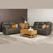 A modern living room with two dark gray leather sofas, including the Russo Electric Recliner - Leather, decorated with throw pillows, a wooden coffee table with books and a candle, a wooden cabinet with vases and greenery, and a light rug on wood flooring.