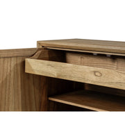 A close-up of the Solstice Large Sideboard, a mid-century modern cabinet in natural solid wood, shows one door open and a drawer partially pulled out to reveal its interior shelves and striking grain patterns.