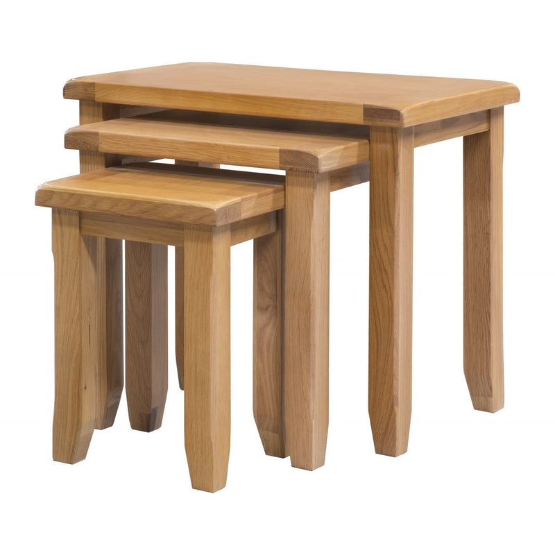 The Saoirse Nest Of Tables includes three premium oak tables with rectangular tops and sturdy legs. Each table fits neatly under the other, highlighting classic solid oak design and practical elegance for any space.