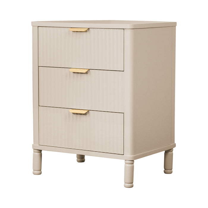 The Parson Locker is a beige 3 drawer nightstand with gold handles and vertical grooves, offering stylish bedroom storage on four short legs.