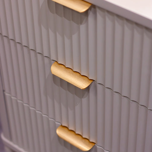 Close-up of the Parson Locker featuring 3 drawers with gray ribbed fronts and gold curved handles. Its vertical grooves and modern angles add a stylish, industrial touch to any locker-inspired space.