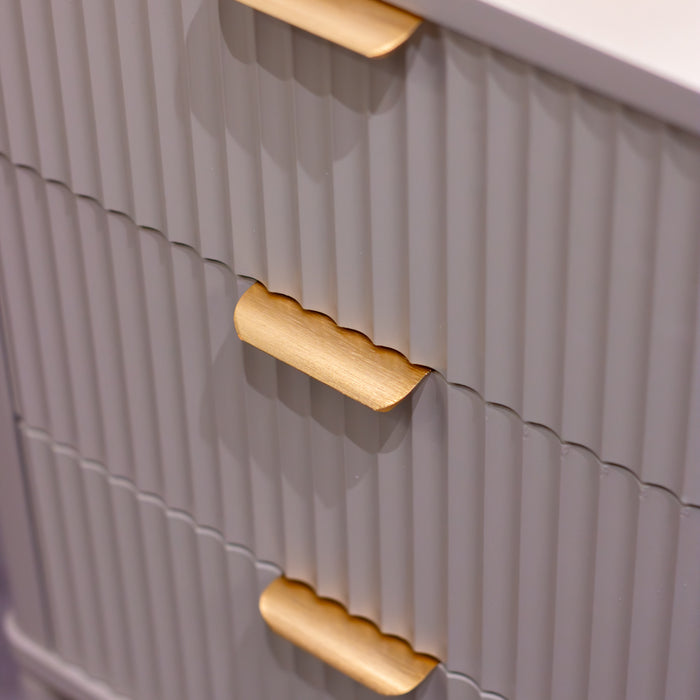 Close-up of the Parson Locker featuring 3 drawers with gray ribbed fronts and gold curved handles. Its vertical grooves and modern angles add a stylish, industrial touch to any locker-inspired space.