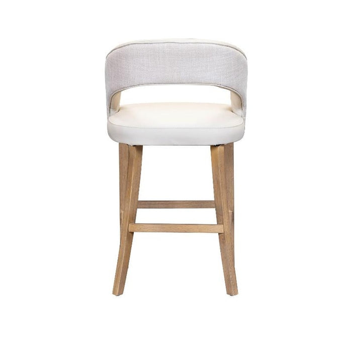 The Willow Counter Stool is a modern seat with light beige upholstery, a backrest cutout, and four wooden legs in a natural finish with a horizontal footrest. Set against a white background.