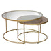 The Andree Coffee Table set includes two round nesting tables: the larger has a glass top with a gold metal frame, while the smaller table features a wooden top and fits neatly underneath.