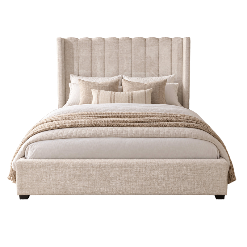 Kildare Storage Bedframe with a tall, vertically channeled headboard, made up with pillows and a knit throw blanket.