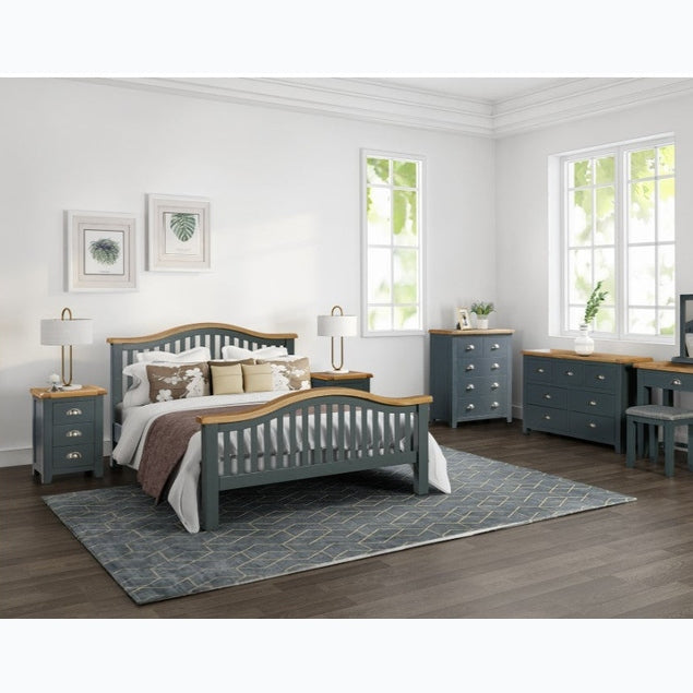 Bedroom with a bed, dresser, and other furniture pieces.