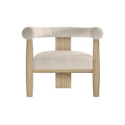 The Dakota Armchair features natural oak legs and frame, a curved upholstered backrest, and a cream cushioned seat, shown on a white background—making it ideal for any contemporary living room.