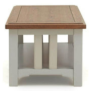 The Eden Coffee Table features a handcrafted solid oak top, soft grey base, and a lower storage shelf. Its simple, modern design offers clean lines and sturdy construction—perfect for any living space.