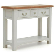The Eden Console Table features a solid oak light brown top, two drawers with metal handles, and a lower shelf. Its frame and legs are painted Soft Grey, giving this wooden piece a modern look.
