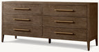 The Hampshire Wide Chest features a dark wood finish, six drawers in two rows with long gold handles, and stands on four tapered legs.