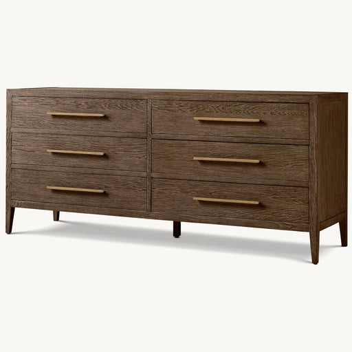 The Hampshire Wide Chest features a dark wood finish, six drawers in two rows with long gold handles, and stands on four tapered legs.