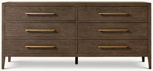 The Hampshire Wide Chest is a modern wooden dresser with a dark wood finish, six drawers featuring long slim gold handles, and short angled legs, perfect for adding style and storage to your bedroom.