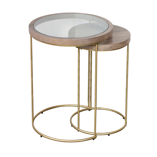 The Hannah Nest of Tables combines modern gold legs with stylish wood, featuring a round glass-topped table and a smaller wooden one that nests beneath, offering chic, space-saving elegance.