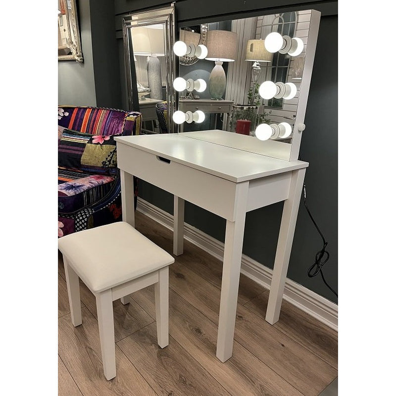 Modern white vanity desk with a single drawer and an attached lighted mirror, paired with a white padded stool, set against a dark wall.