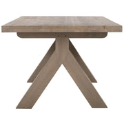 The Marlo Y Leg Table features a thick rectangular top and distinctive crossed-leg base in a light natural wood tone, showcased against a white background.