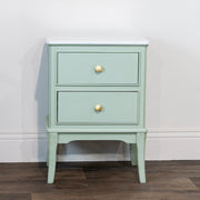 Small vintage-style bedside cabinet with brass knobs.