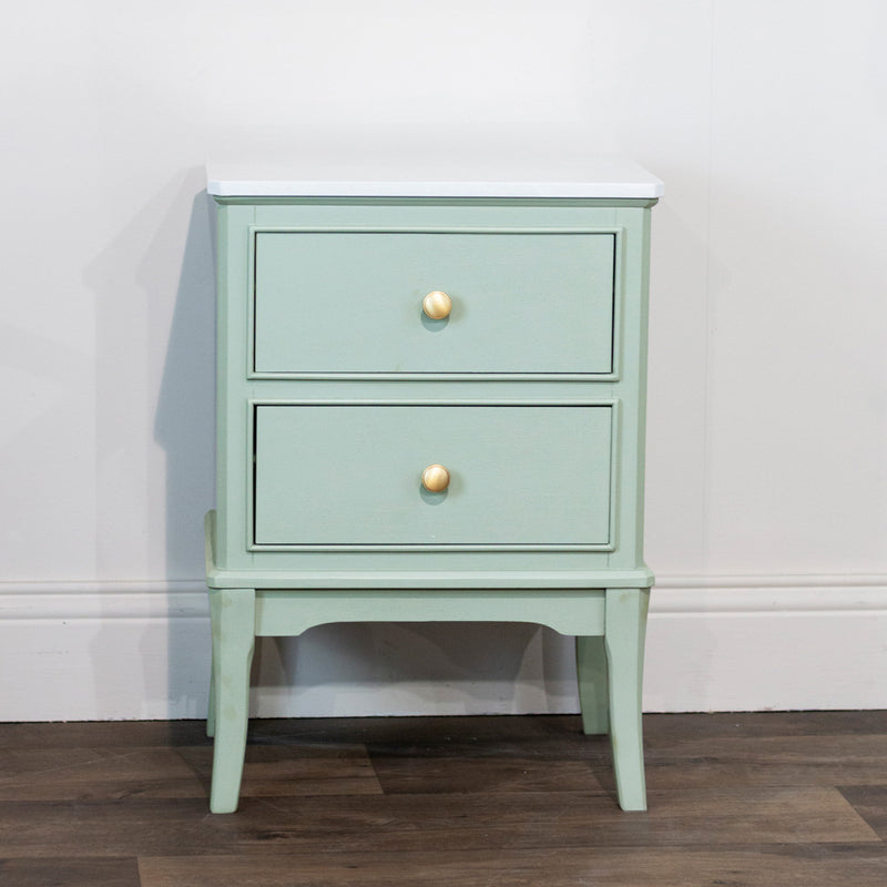 Small vintage-style bedside cabinet with brass knobs.