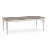 The Montreux Range 180cm-225cm Set is a rectangular dining table with a light brown top and white legs, showcasing a simple, modern style. Pair it with wooden or leather chairs for an elegant dining setup.