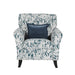 The Pippa Accent Chair features white and dark blue upholstery with a leaf pattern and includes a square dark blue throw pillow centered on the backrest.