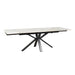 The Sorrento Dining Table features a white marble top and black angular metal legs in a striking starburst pattern.