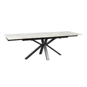 The Sorrento Dining Table is a modern extendable piece with a white marble top and black metal legs in a distinctive angular design.