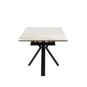 The Sorrento Dining Table features a rectangular white marble top and black metal legs, shown from the short end against a plain white background.