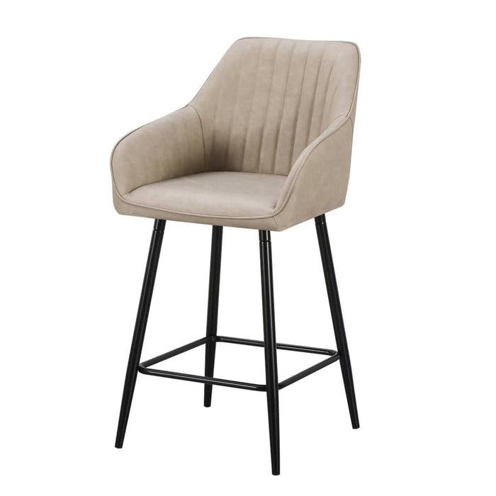 The Enzo Counter Stool features a modern design with a light beige upholstered seat and backrest with vertical stitching, armrests, and four slim black metal legs with a footrest.