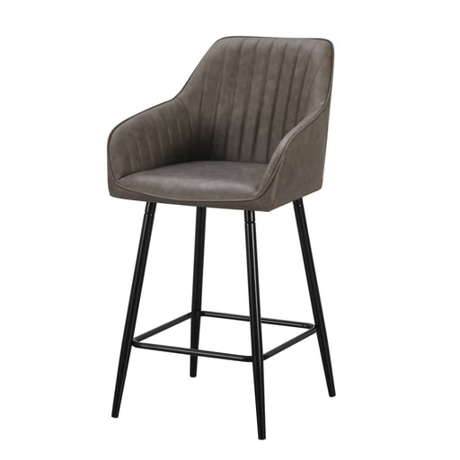 The Enzo Counter Stool features a grey faux leather seat with vertical stitching, low armrests, black metal legs with footrests, and cushioned seating for added comfort.
