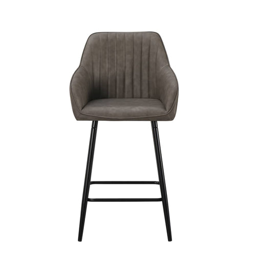 The Enzo Counter Stool features a modern design with a padded gray faux-leather seat with vertical stitching, curved armrests, and four slender black metal legs with a footrest.