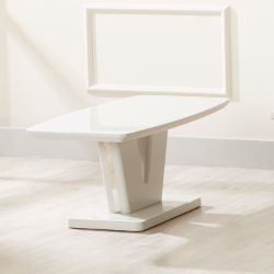 The Vicenza Coffee Table, featuring a modern angular white design with a matching rectangular frame, stands on a light wooden floor in a bright, minimal room.