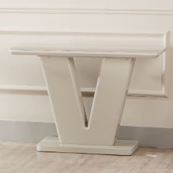 The Vicenza Console Table is a modern, glossy white piece shaped like a V and features a scratch-resistant finish for lasting elegance.